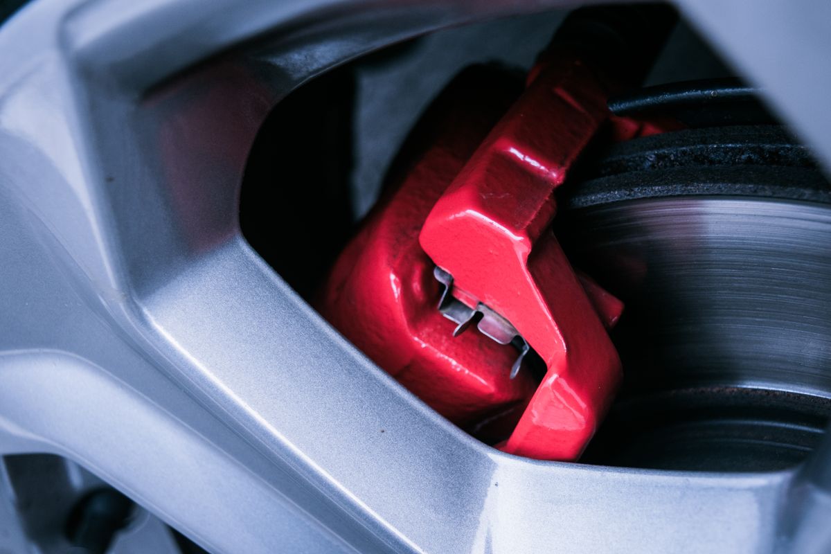 Close-up of a red brake caliper and rotor
