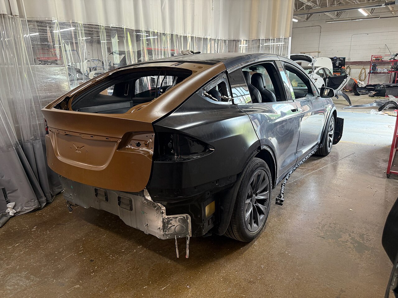 Vehicle collision damage being repaired in body shop